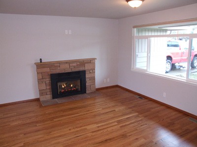 new livingroom with hardwood floors and remote controlled fireplace